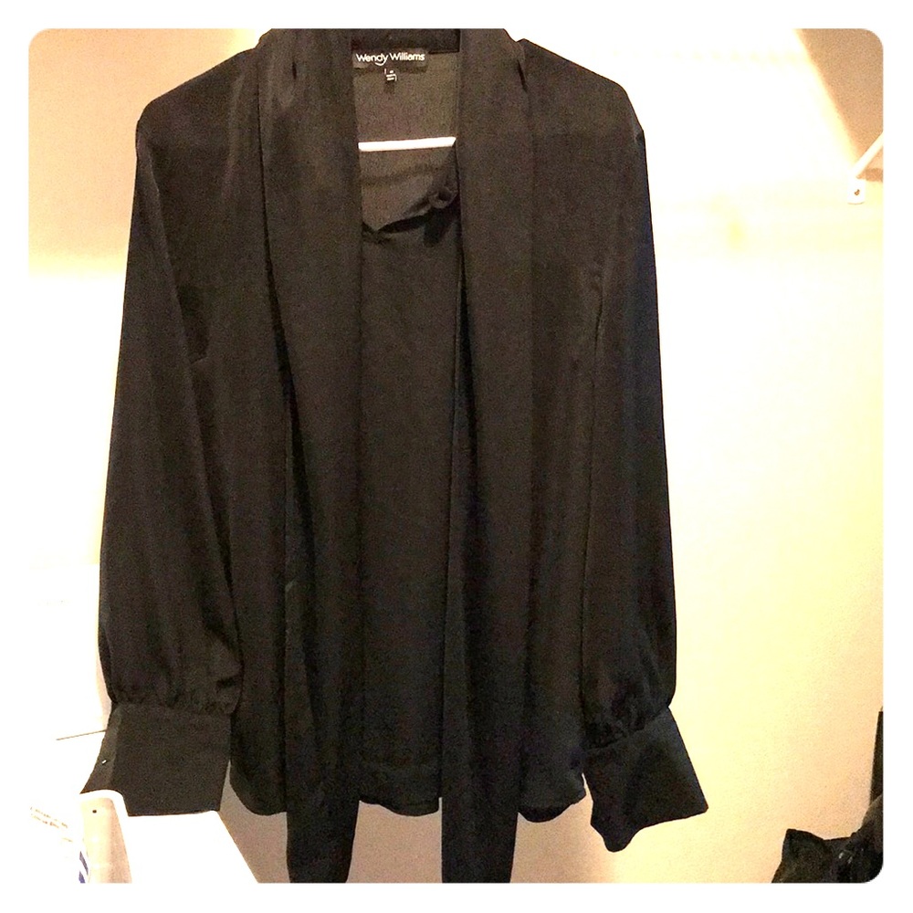 black blouse ties into a bow around the neck